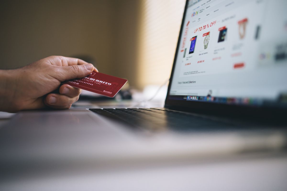 Online shopping with a bank card and laptop